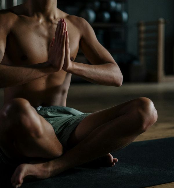 Person in a meditative pose, finding calm and focus through breathing.