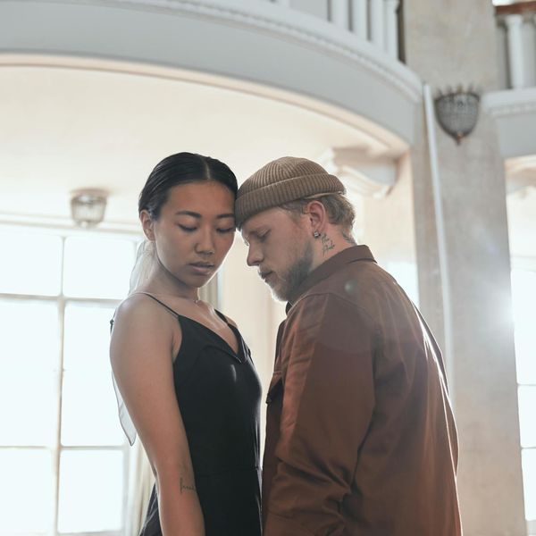Woman performing a gentle cardio movement in a calm studio environment.